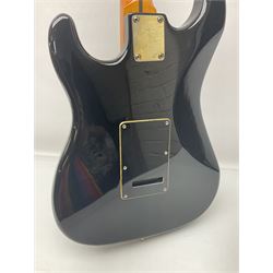 Copy of a Fender Stratocaster electric guitar in black with Wilkinson bridge, lock-in tuners, synchronised tremolo and various patent numbers; L99cm; in hard carrying case with strap and digital tuner