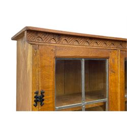 Gnomeman - adzed oak dresser, arcade carved cresting rail over two lead glazed doors, double cupboard below enclosed by two panelled doors, carved with gnome signature, by Thomas Whittaker, Little Beck 