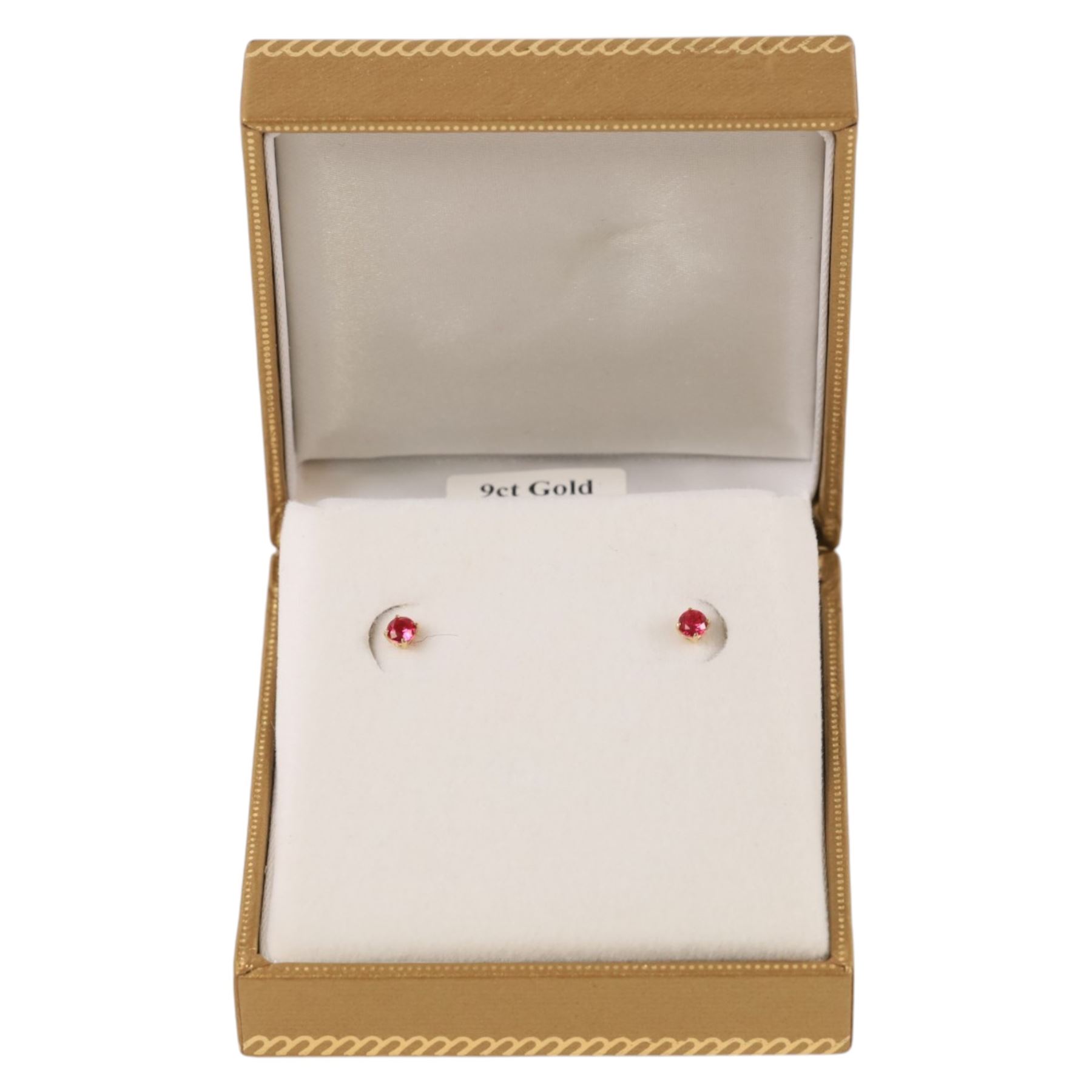 Pair of 9ct gold ruby stud earrings, boxed