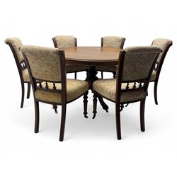 Victorian mahogany centre table, circular top above turned pedestal, terminating on three cabriole legs with scroll feet on porcelain castors, and six scroll carved upholstered dining chairs, with cushion and spindle turned backs, centre table  118x74cm, dining chairs 89x46x50cm