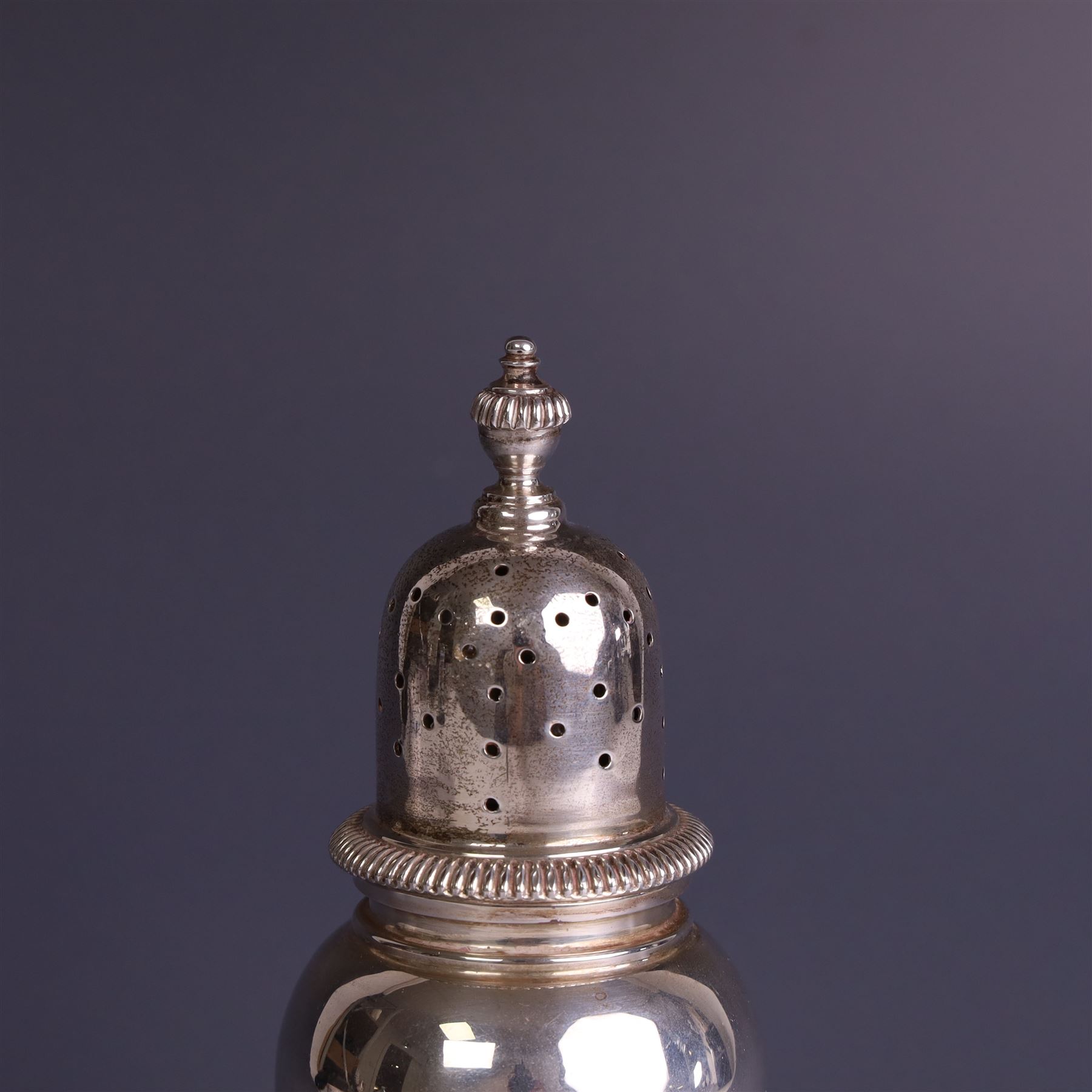 Mid 20th century silver sugar shaker, of typical baluster form, the removable pierced cover with urn finial, hallmarked William Comyns & Sons Ltd, London 1961