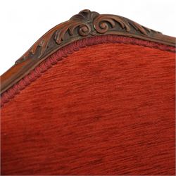 19th century Rococo revival upholstered armchair, red textured fabric over a carved walnut frame, shaped back and sides, floral carved serpentine seat rail, on cabriole supports 