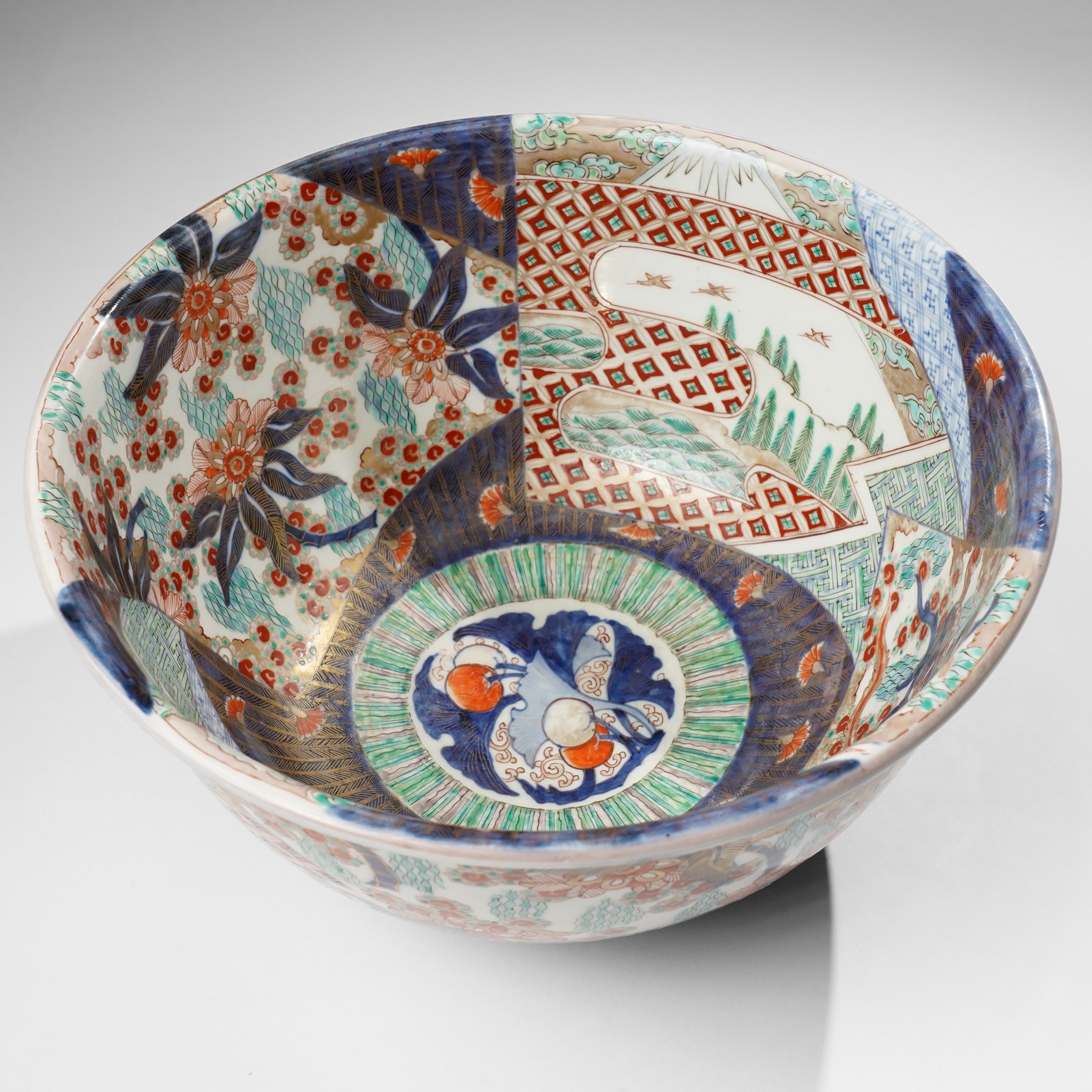 Japanese 19th century Imari bowl, painted profusely internally and externally with landscapes, flowers and traditional motifs, H16.5cm 