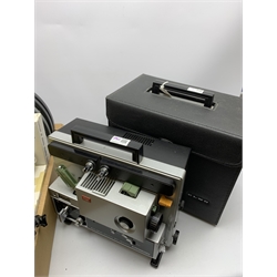 Two 'ELMO Sound ST-1200D' super 8 sound projectors, one in a carry case with photocopy of the original instruction manual, together with various film reels, spare bulbs and other accessories