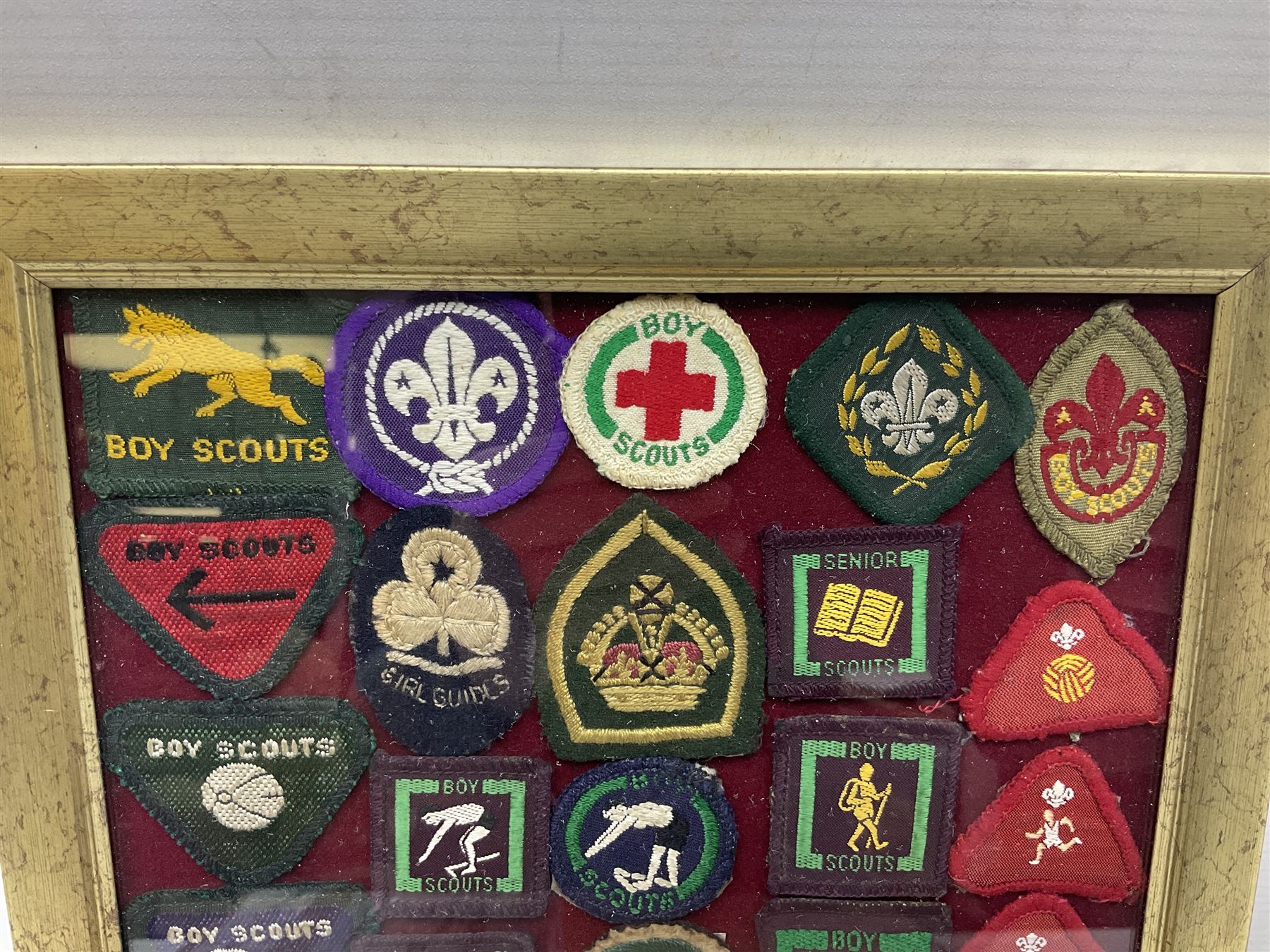 Boy Scout Interest; framed collection of Boy Scouts cloth insignias, to include badges from East Yorkshire, Northumberland, West Yorkshire, Devon, Norfolk and Derby, thirty four badges in total  