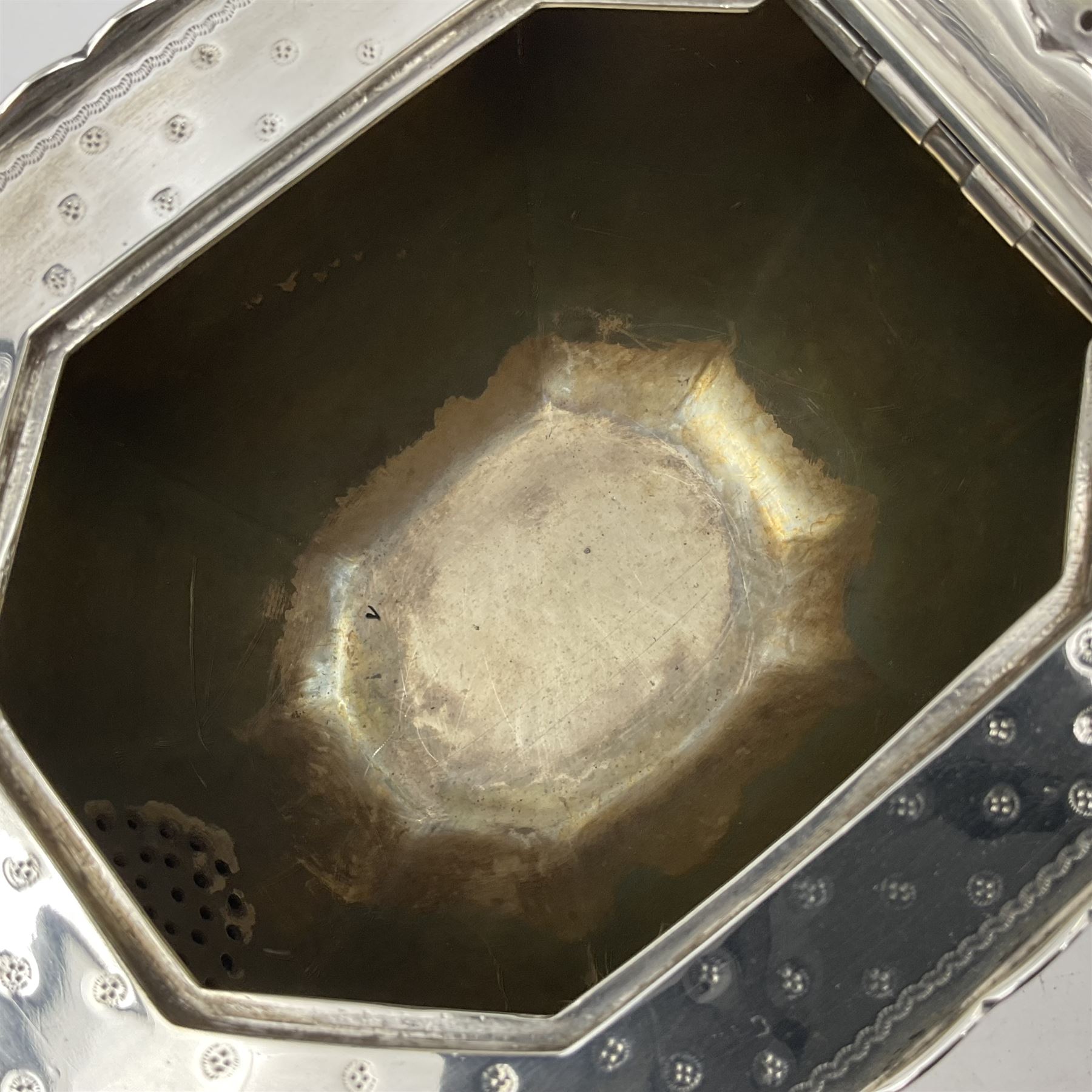 Victorian silver four piece tea service, comprising teapot, teapot stand, twin handled open sucrier and milk jug, each of octagonal form with foliate bud border and engraved decoration including crest to canted panels, and vacant panels, the teapot with ivory finial to the hinged cover and later wooden handle, hallmarked Edward Barnard & Sons Ltd, London1896, teapot including finial H15cm, milk jug including handle H16cm, teapot stand W11.5cm

This item has been registered for sale under Section 10 of the APHA Ivory Act