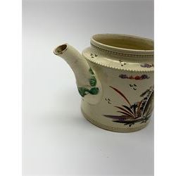 18th century creamware teapot, probably Leeds, with reeded entwined handle and floral finial to the cover, the body with hand painted polychrome decoration of figure to one side, and floral spray to the other, collectors paper label beneath inscribed Leeds Pottery, H11.5cm