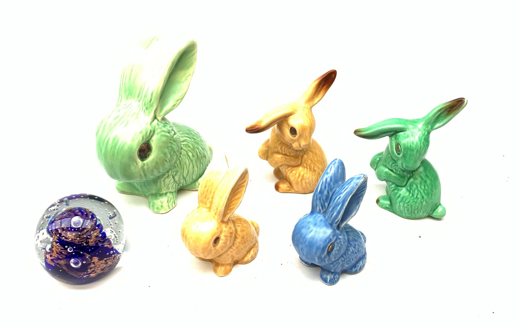  Five Sylvac Rabbits, to include a large example marked 1026, etc., together with a Caithness glass paperweight.   