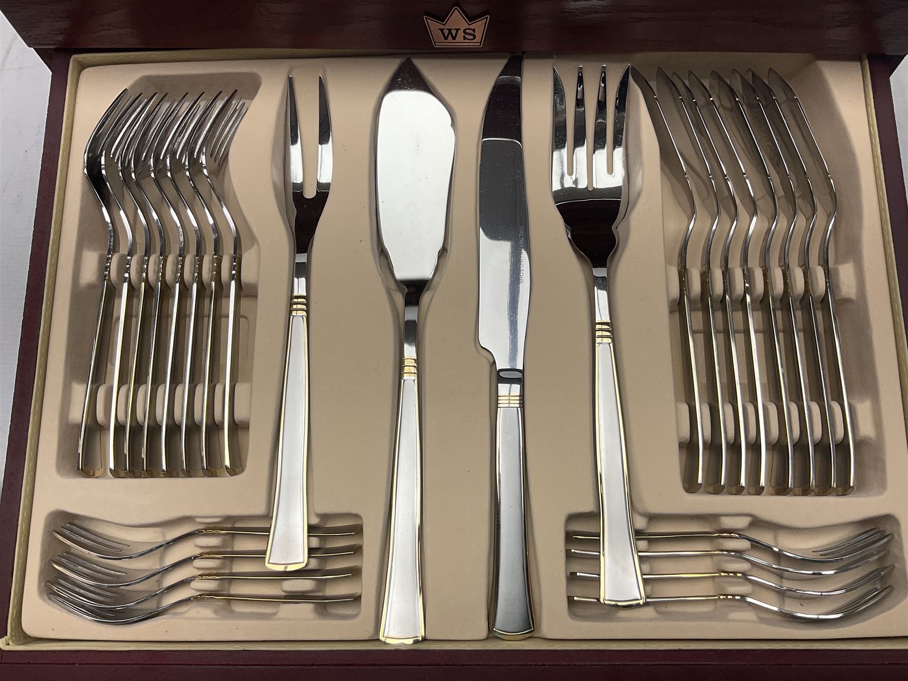 Waltmann und Sohn part canteen of stainless steel and gilt cutlery, the stained wood case with hinged lid above two fitted drawers, L48cm