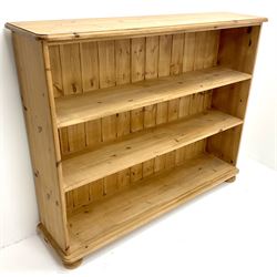 Solid pine open bookcase, moulded top, two shelves, bun feet