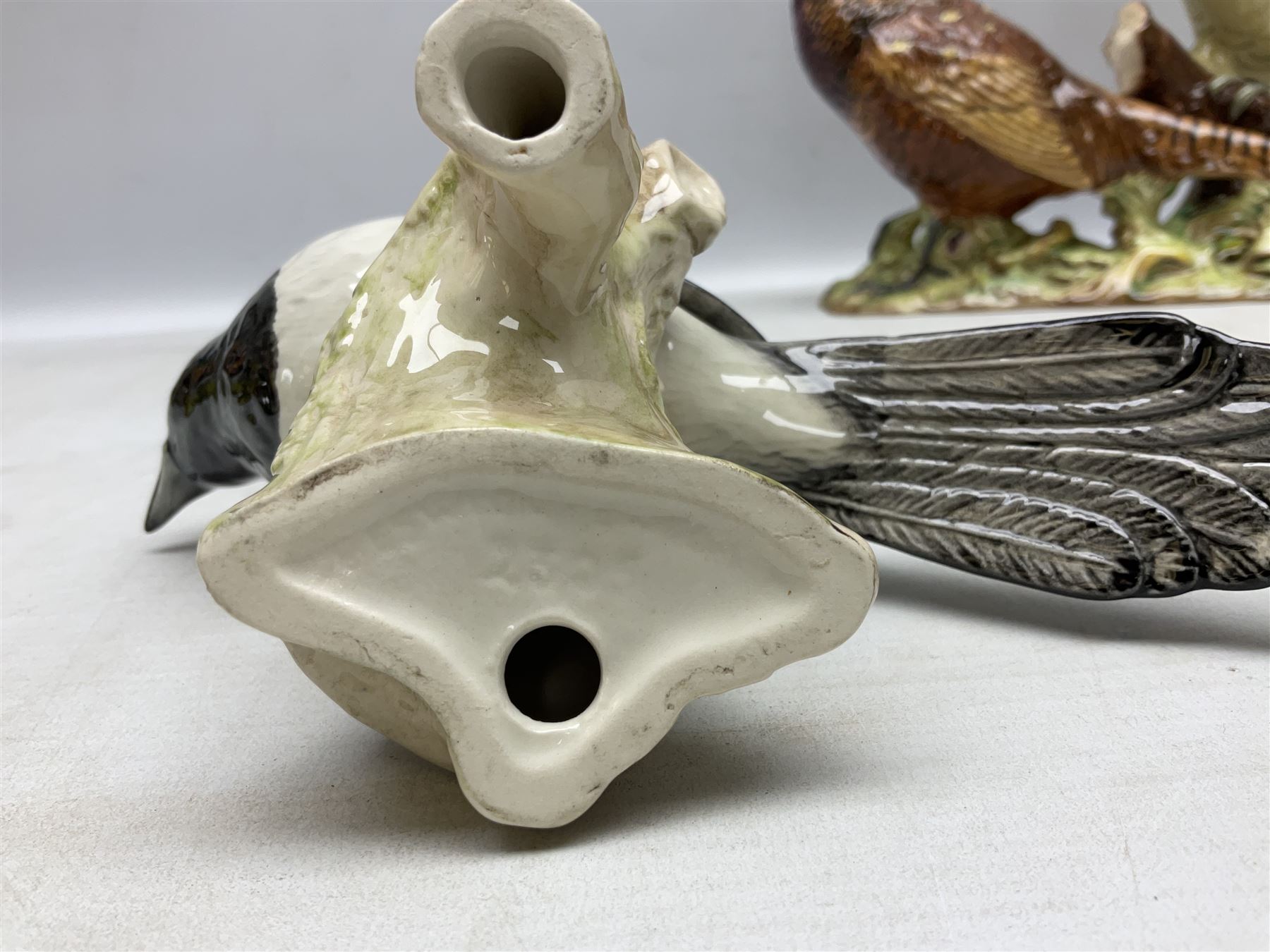 Three Beswick figures of birds, comprising pheasant no 1225, magpie no 2305 and woodpecker 1218, all with impressed marks beneath, tallest H22cm