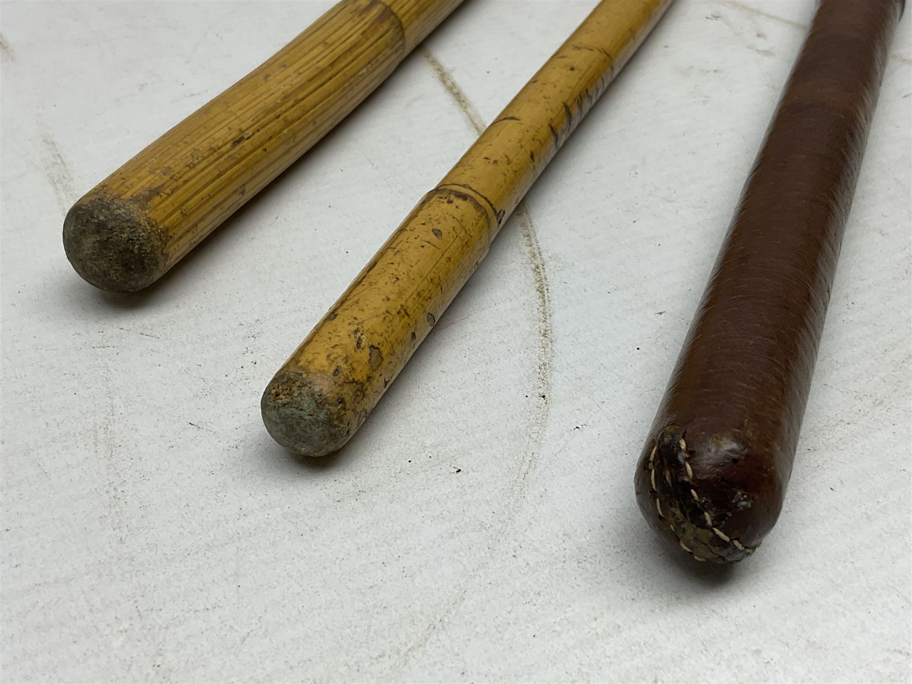 WW2 copper and brass bugle inscribed George Potter & Co, Aldershot 1939 L28cm; two cane and one leather covered swagger sticks; and three small pairs of plain brass shell cases (10)
