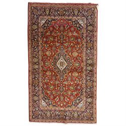 Central Persian Kashan hand-knotted rug, deep red field with central cusped ivory medallio...
