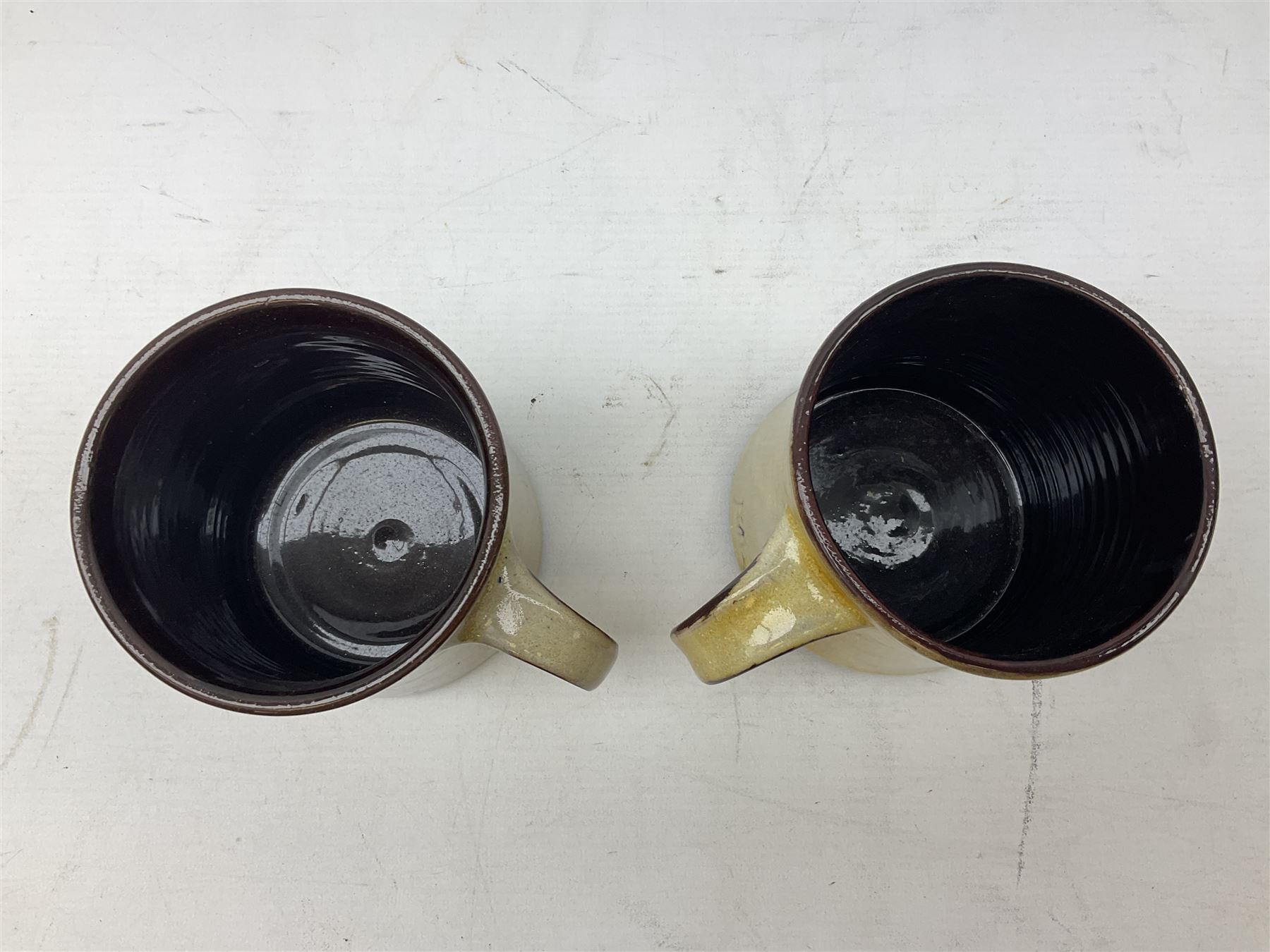 1960s Chelsea Pottery mug decorated with barrister by Joyce Morgan, signed JEM, together with a similar example depicting a doctor, H11.5cm, both signed beneath