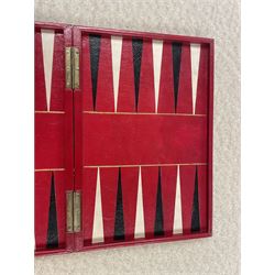 19th century walnut and brass bound games compendium box, painted to enhance the grain, of rectangular form, the hinged opening cover with rounded sides, central brass cartouche with engraved lion crest, and brass riveted straps, opening to reveal a red leather and blue silk lined compartmented interior, with fold-down games board, and lift-out tray containing playing cards, ebony turned dice towers, white and red stained bone draughts, and chess pieces, ivory dice, and ivory and ebony whist markers, and brass bezique board, cribbage board and markers, H15cm W32cm D24cm
This lot has been registered for sale under Section 10 of the APHA Ivory Act