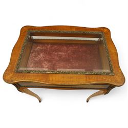 Louis XV revival style walnut bijouterie table, rectangular serpentine form, with brass edging and a hinged floral marquetry inlaid lid with bevelled glass top and sides, gilt-bronze beaded border, interior lined with rich red velvet, raised on slender cabriole legs with gilt bronze masks and sabots, circa 1900