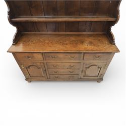 Georgian design oak dresser, the raised plate rack with shaped sides and two open shelves, upon a dresser base fitted with six drawers and two cupboard doors, and short block feet 