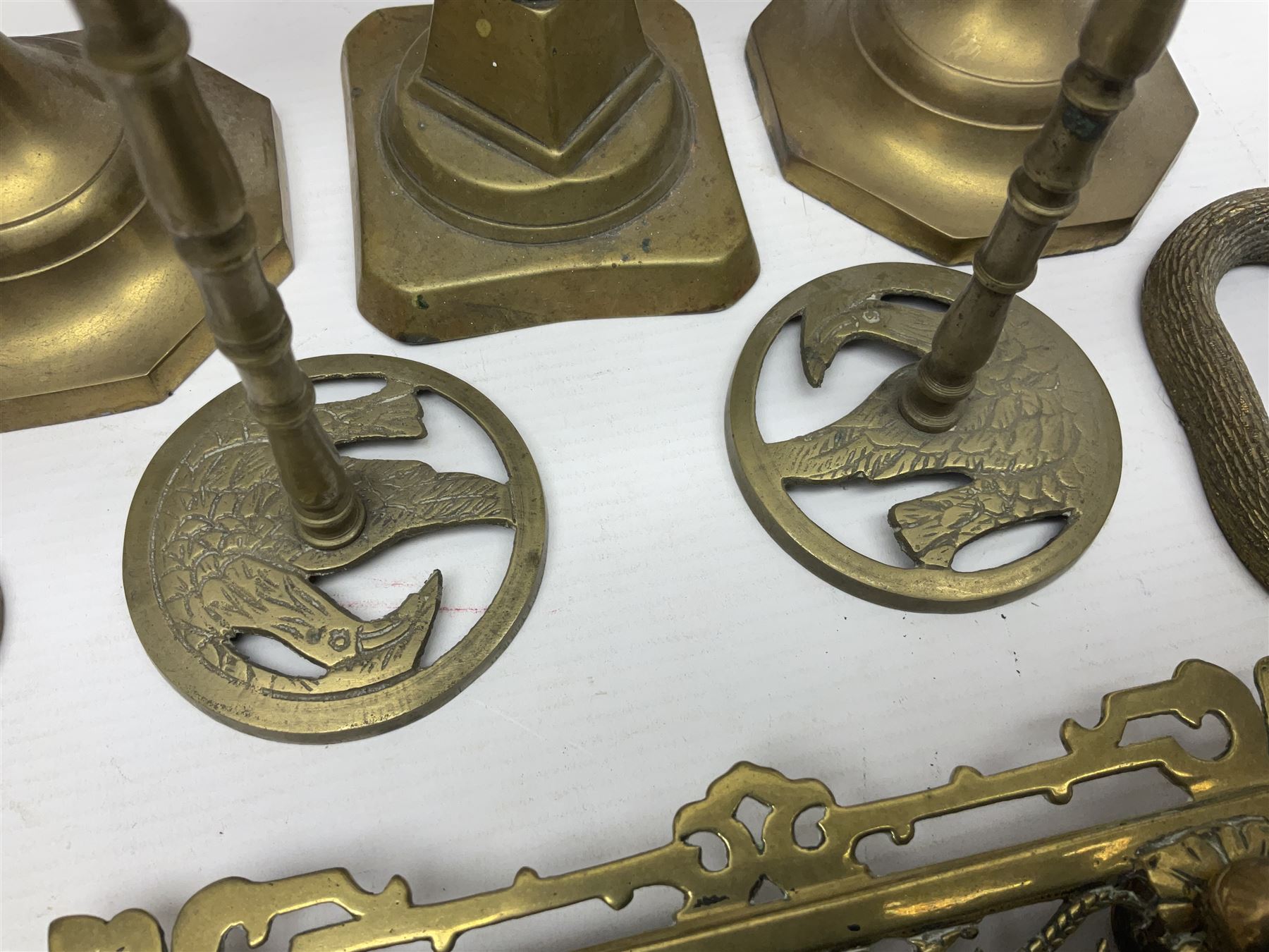 Brass inkstand, of square form, pierced, inset with blue and white ceramic inkwell to centre, together with a collation of brass candlesticks 