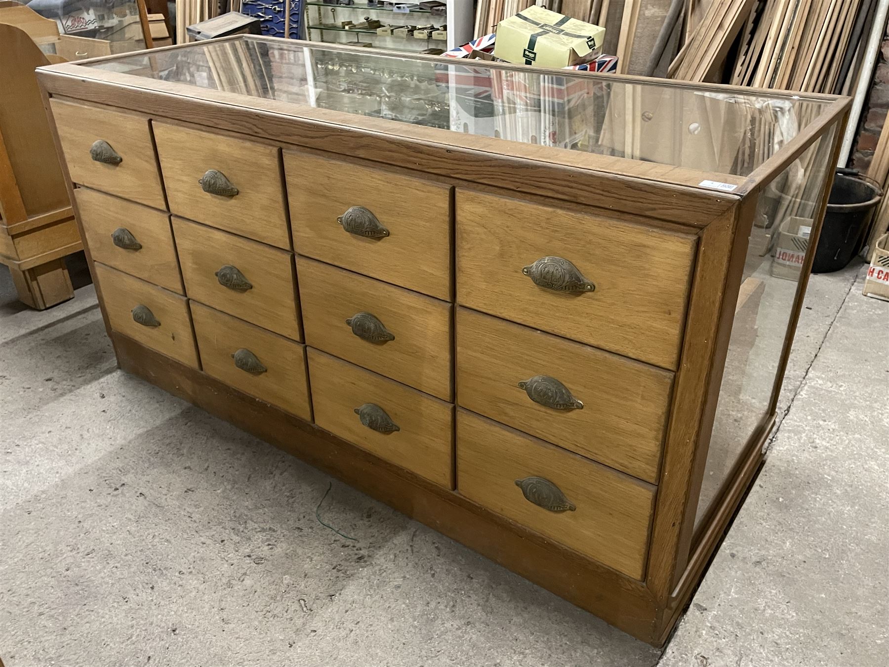 20th century oak and glazed haberdashery shop's display cabinet, fitted with twelve slides, on skirted base - THIS LOT IS TO BE COLLECTED BY APPOINTMENT FROM THE OLD BUFFER DEPOT, MELBOURNE PLACE, SOWERBY, THIRSK, YO7 1QY