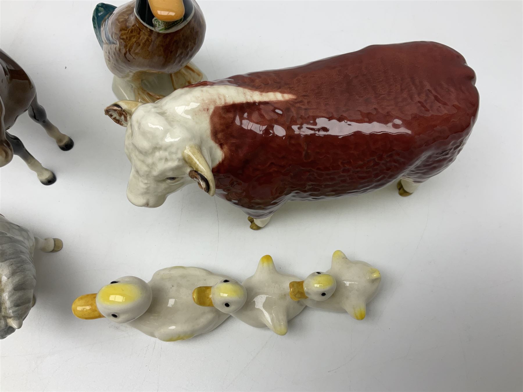 Beswick Champion of Champions Hereford bull figure no 1360, Beswick Norman Thelwell An Angel on Horseback no 2704A, and three other Beswick figures to include Arab Bay horse, Mallard and Comical Duck Family, all with printed or impressed marks beneath, largest H17.5cm