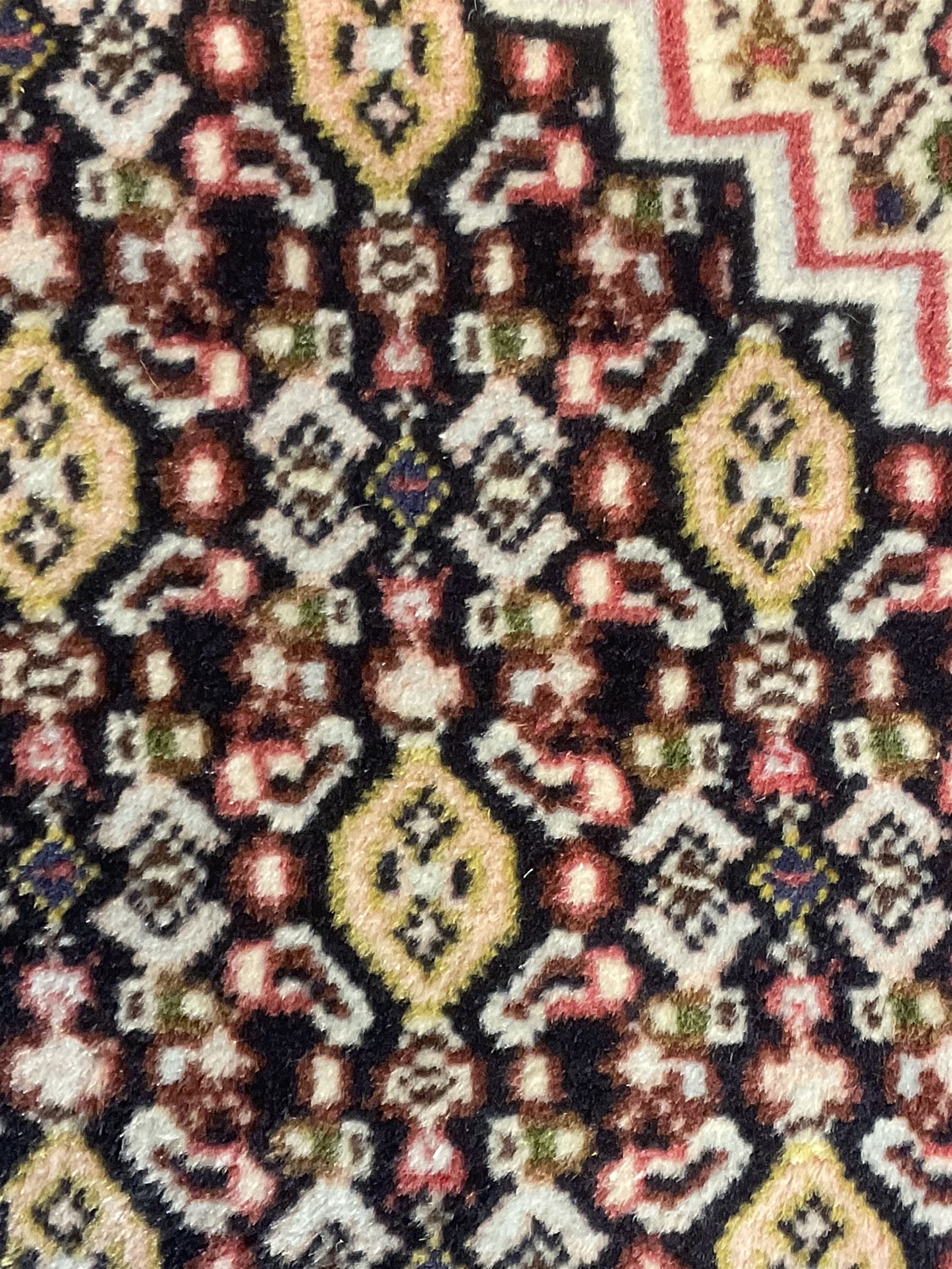 Small Persian Bidjar rug, the field decorated with floral Herati motifs, within floral design borders and guard stipes 
