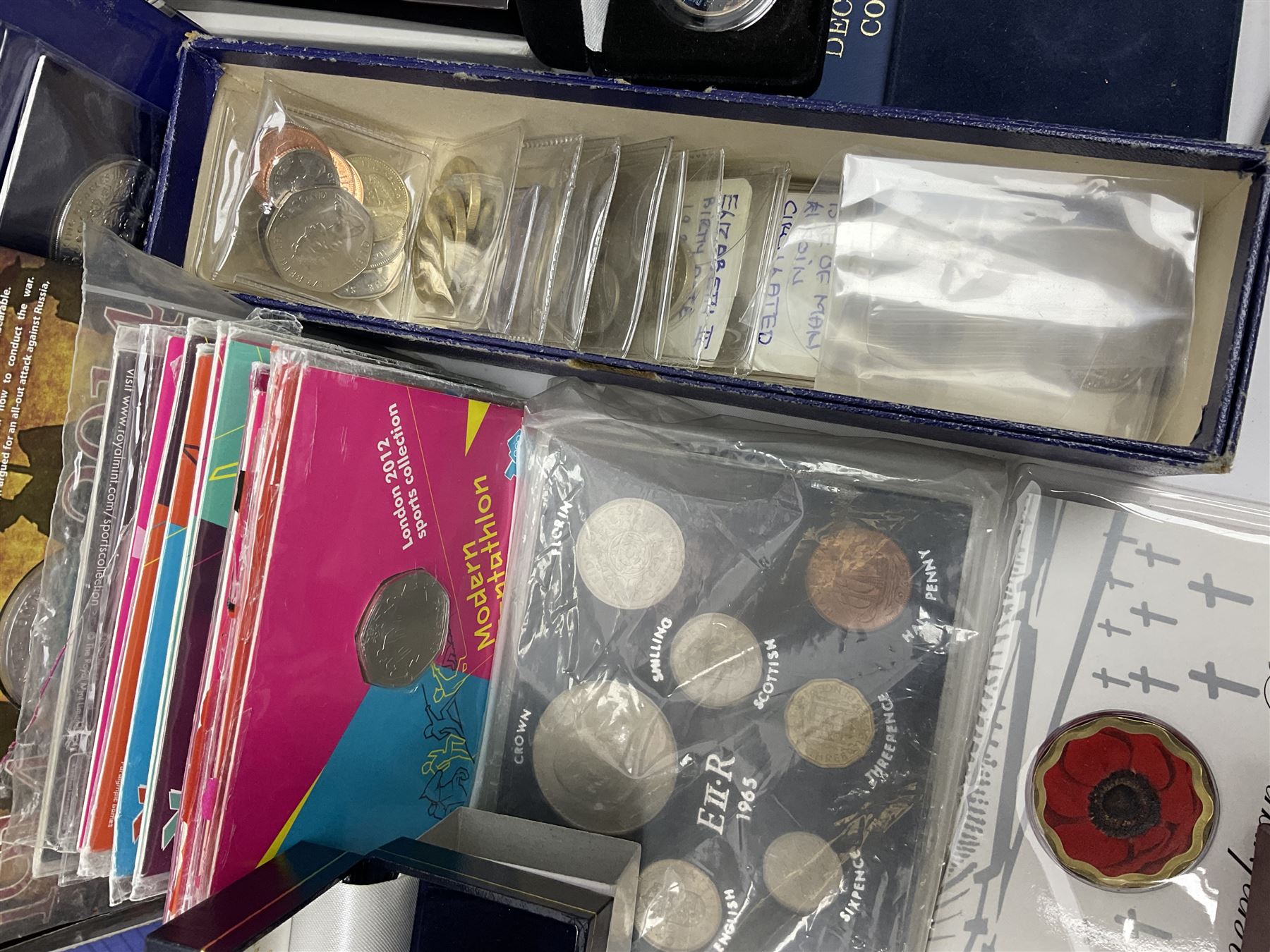 Commemorative and other coinage, including various Queen Elizabeth II 'London 2012 sports collection' fifty pence coins on cards, commemorative crowns, Millennium 2000 'Time Capsule' coin set, channel islands old round one pound coins, part sets etc
