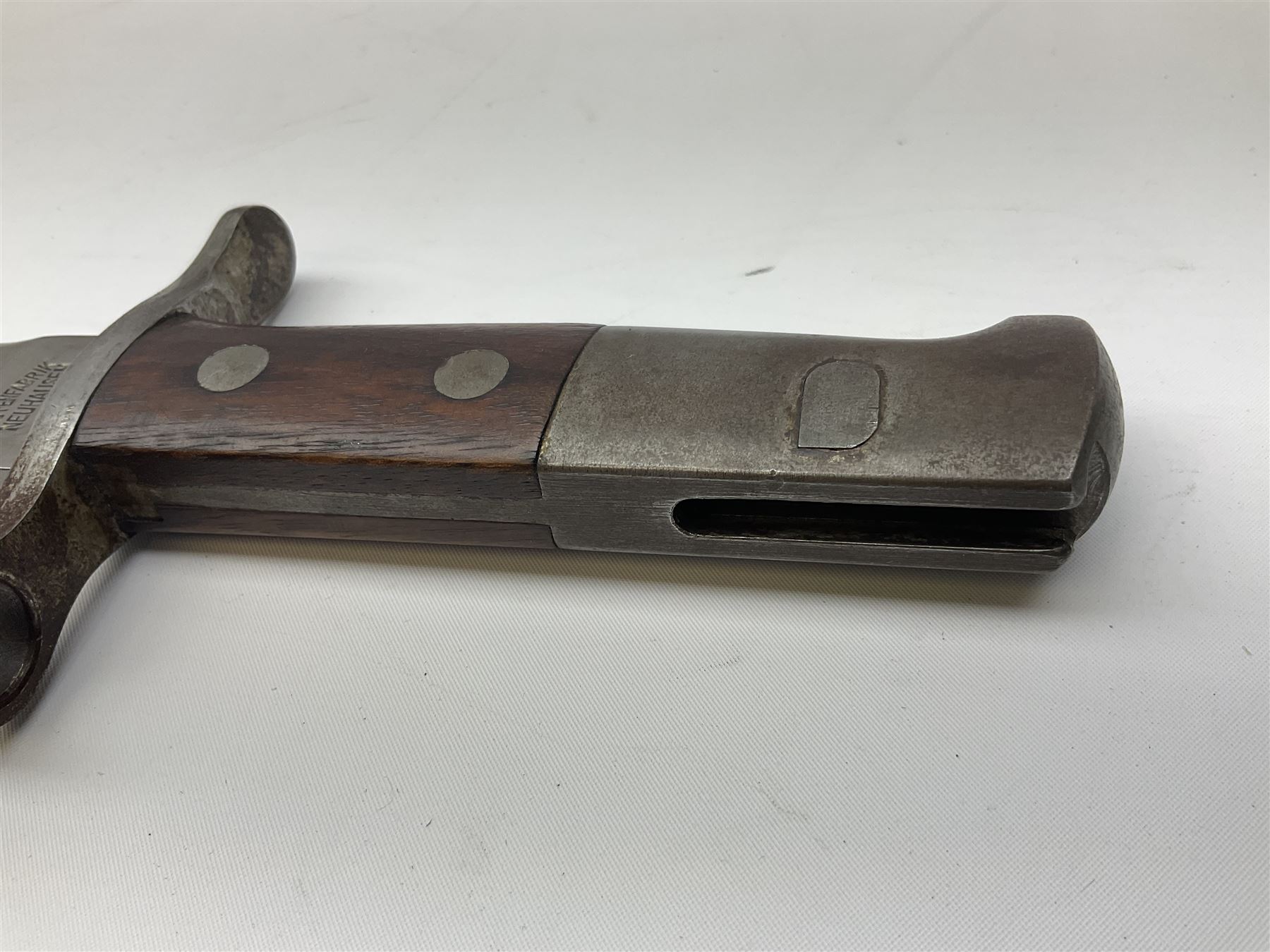 Swiss Schmidt-Rubin M1914 pioneer bayonet, with 48cm steel saw-back blade, the ricasso stamped, ''Waffenfabrik, Neuhausen'', the crosspiece stamped Swiss cross, steel scabbard, leather frog L64cm overall