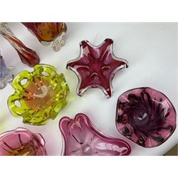 Quantity of art glass to include cranberry coloured examples, vases of stylised form, centrepieces, bowls etc, to include signed example