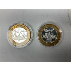 Eight Las Vegas limited edition ten dollar casino silver strike gaming tokens, consisting of a fine silver centre with brass outer ring (8)