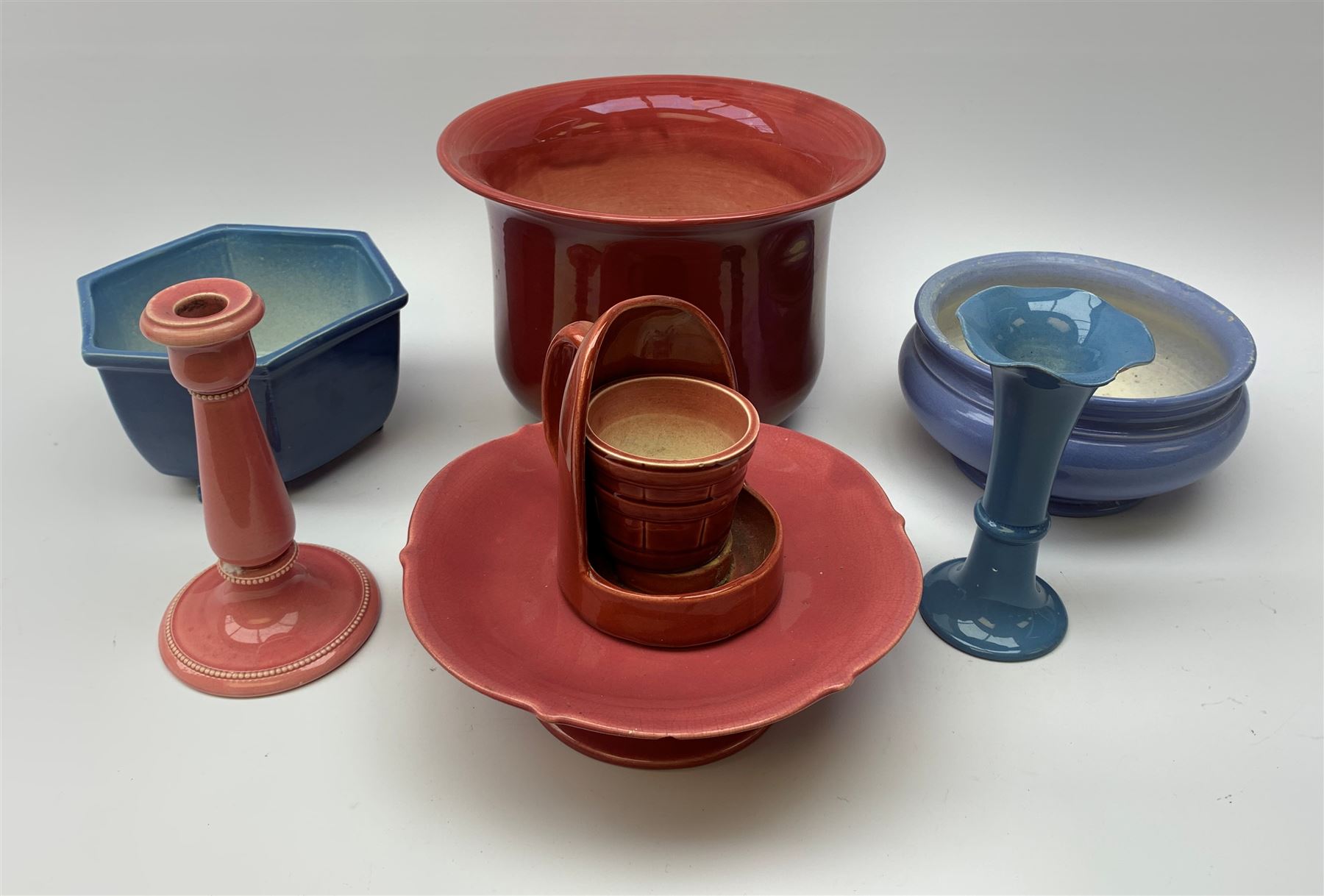 Two Bretby jardinières, hexagonal planter and trumpet shaped vase,  preserve pot and chamberstick together with an Ault pink glazed candlestick and low comport (8)