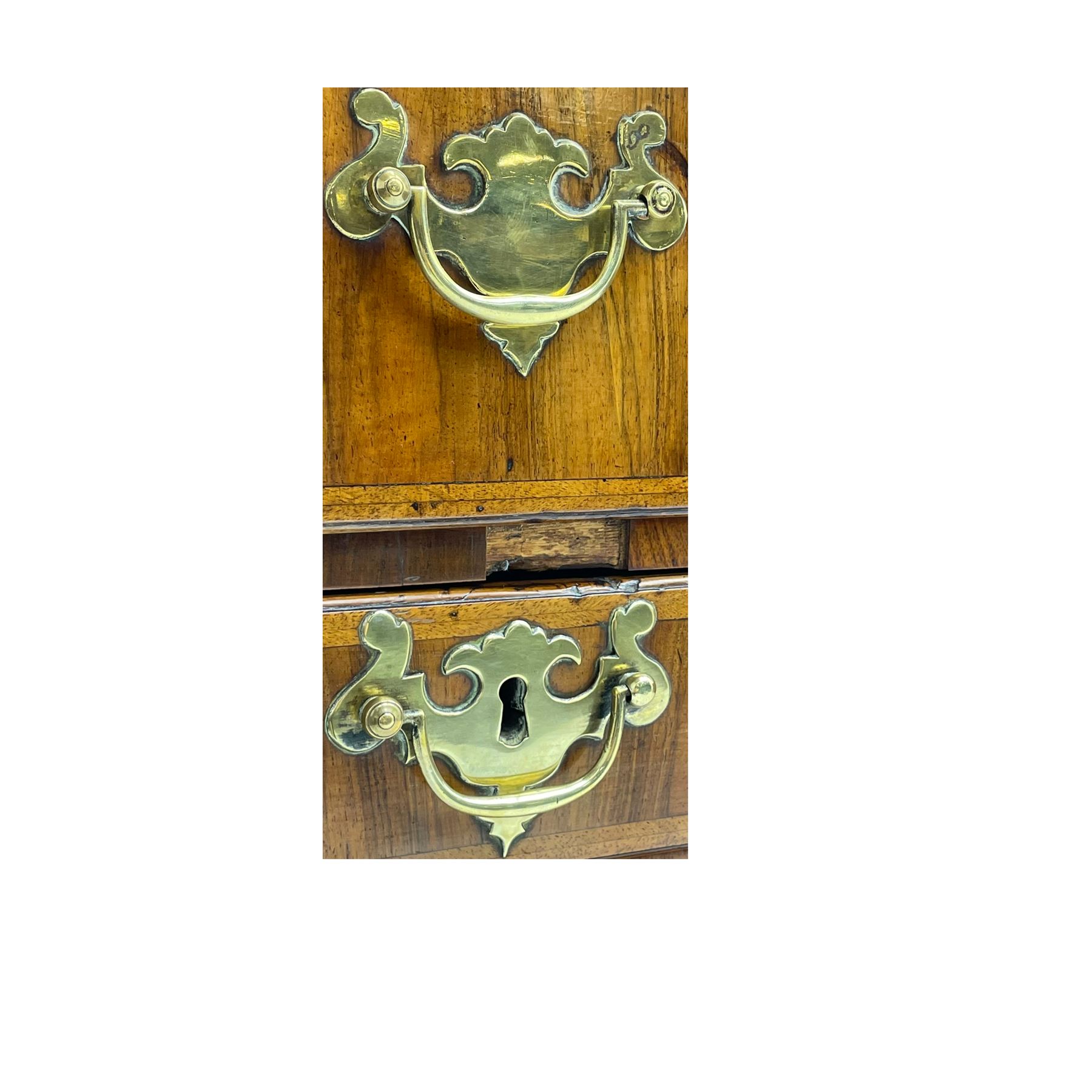 Early 18th century Queen Anne figured walnut kneehole desk with secretaire drawer, moulded and book matched top with walnut band, the top drawer with fall front enclosing small drawers and pigeon holes, fitted with nine drawers and central recessed cupboard, on ogee bracket feet