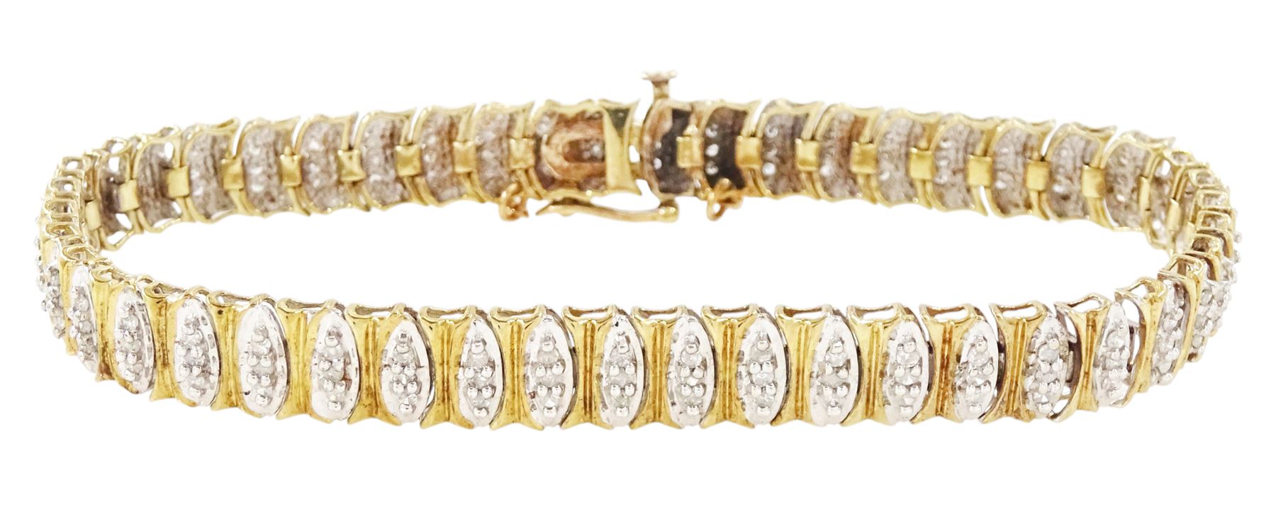9ct gold diamond chip bracelet, forty-six white gold navette shaped links, each set with three single cut diamonds and with yellow gold surround, Birmingham import mark