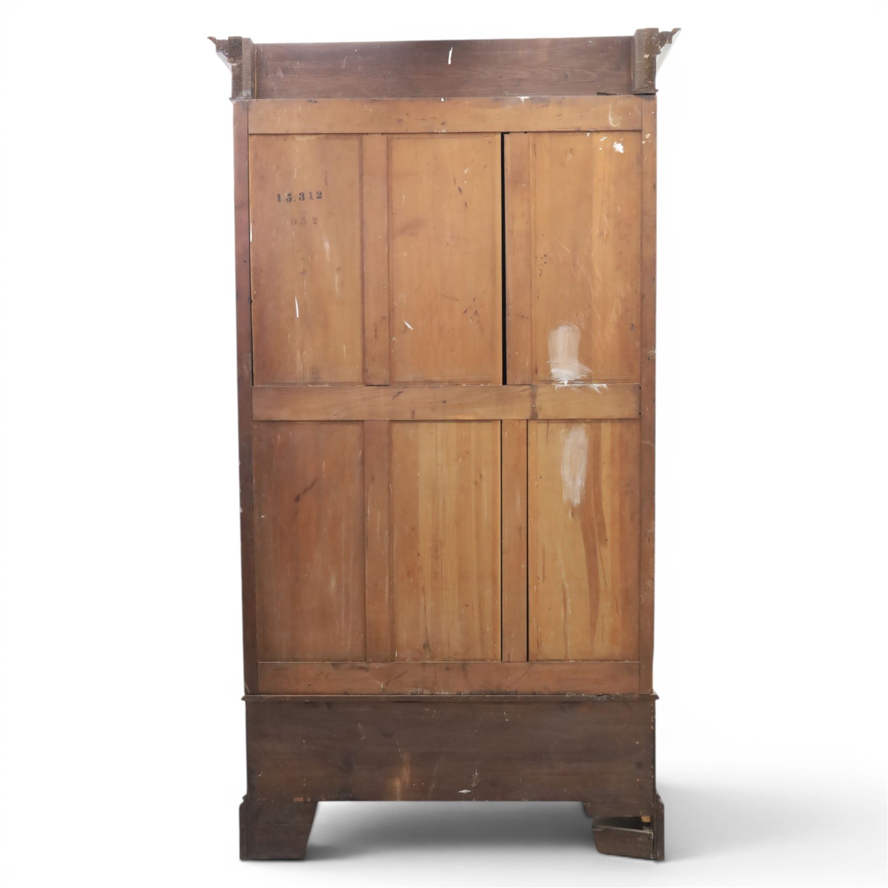 Edwardian walnut double wardrobe, featuring two mirrored doors with bevelled plates, carved frieze with fluted pilasters, above single base drawer