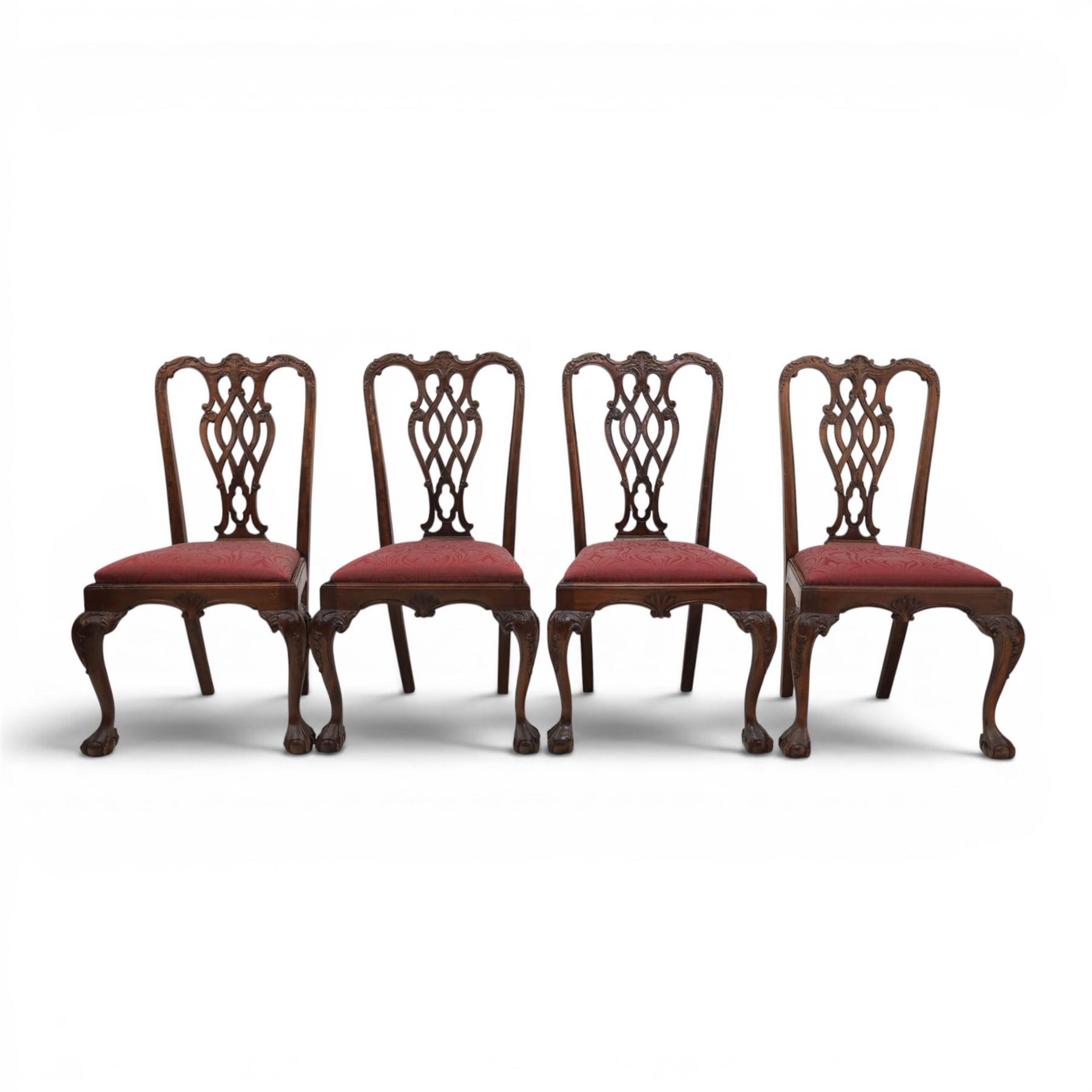 Chippendale design set of ten (8+2) mahogany dining chairs, serpentine cresting rails with carved detail over pierced ribbon-tied splats, red damask upholstered drop-in seats, on cabriole supports with acanthus carved knees and claw and ball feet