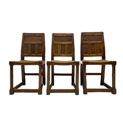 'Gnomeman' set of three oak dining chairs, panelled backs over curved seat rails with drop in rope rush seats, turned front supports with collar joined by plain stretchers, two with carved seated gnome figures, painted

Provenance - This collection of early 'Gnomeman' furniture comes to us directly from the Whittaker family. The pieces were made by the vendor's father Thomas Whittaker in the 1930/40s for his own use. During this time, he lived in York and made items for himself and friends. Whittaker adopted the gnome as a signature and trademark after his move to Littlebeck, Whitby.