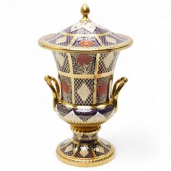 Caverswall Imari pattern campana shape two handled vase and cover decorated in orange, blu...