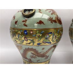 Pair of early 20th century Chinese vases decorated with dragons chasing a flaming pearl, with a gilt border of butterflies and floral sprigs, with Elephant head handles, H44cm 