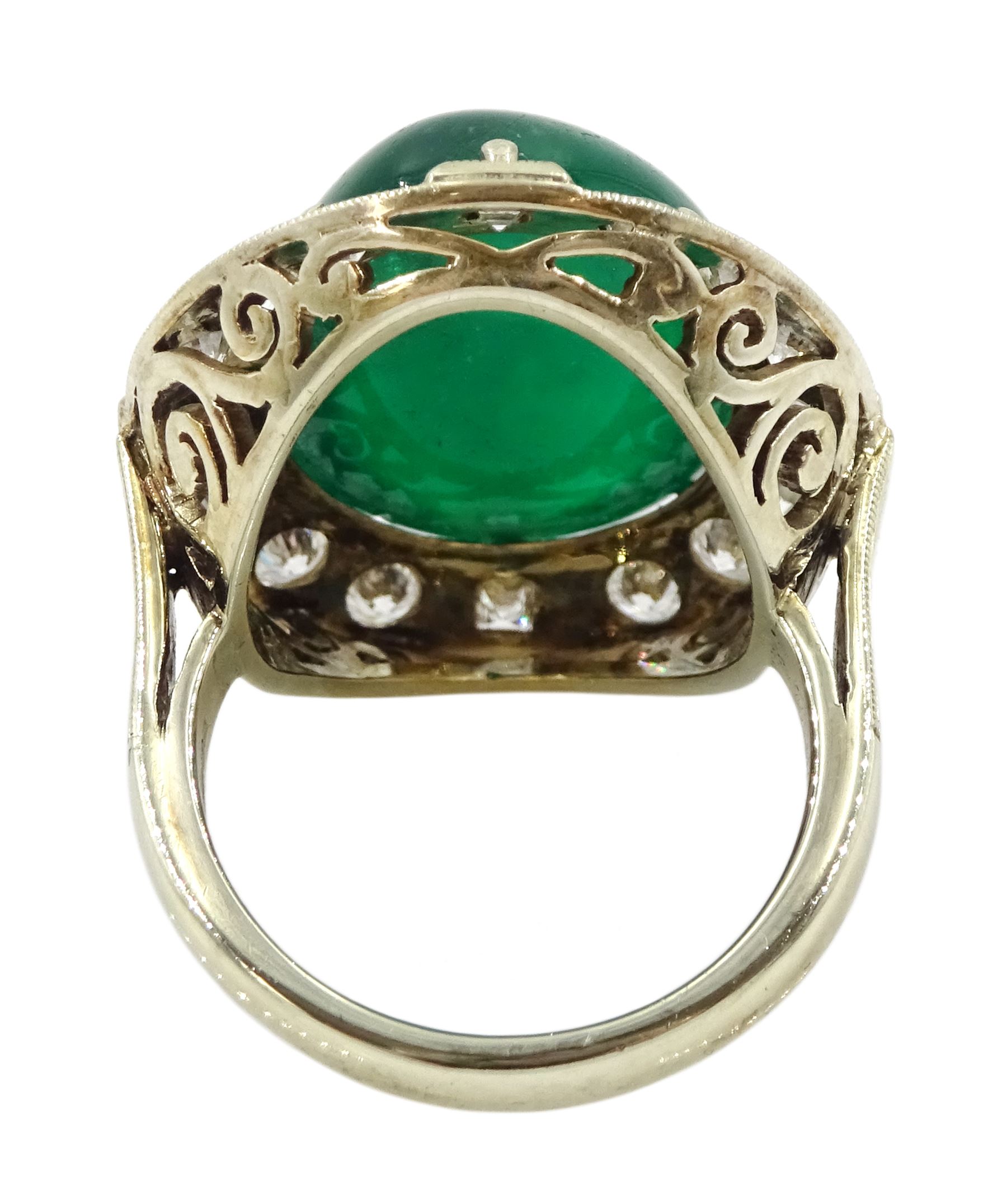 Gold emerald and diamond ring, the central oval cabochon emerald, with sixteen round and rectangular cut diamond halo surround by Judith Crowe, hallmarked 9ct, emerald 20.00 carat, total diamond weight 2.00 carat, with World Gemological Institute report