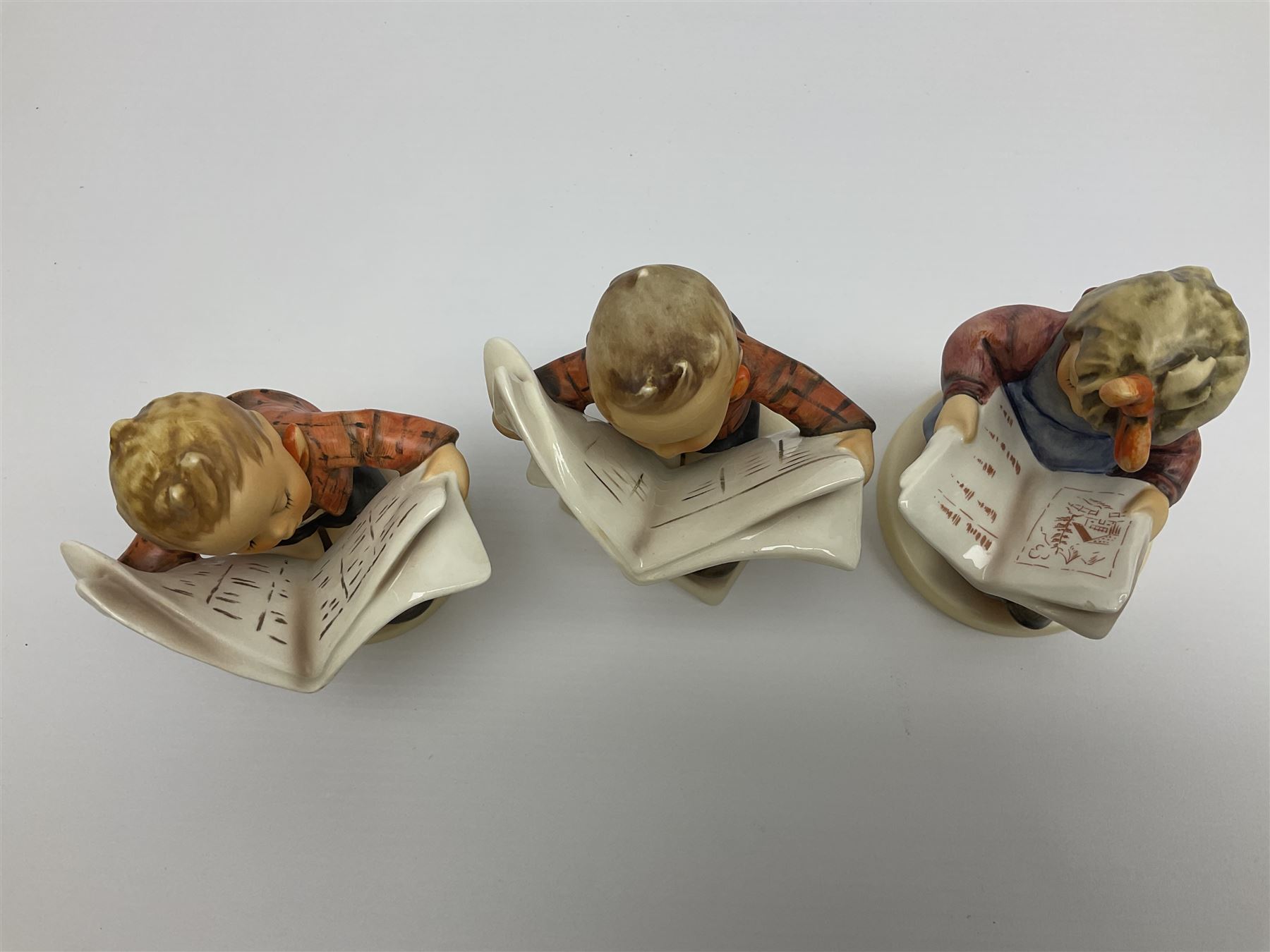 Thirty Hummel figures by Goebel, to include Saluting the Peacekeepers of Operation Joint Endeavor, on wooden plinth, Call to Glory, Celebrate with Song and Soldier Boy