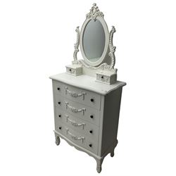 French design white painted dressing chest, oval swing mirror with floral cartouche pediment over two trinket drawers, serpentine chest fitted with four drawers, the facias with applied swags with flower heads
