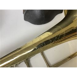 Three brass trombones comprising Elkhart Ind. USA 'CONN' model no.72H; Besson 'Concord'; and Selmer Distributed 'Lincoln'; two in carrying cases; and German B & M 'Champion' brass trumpet (4)