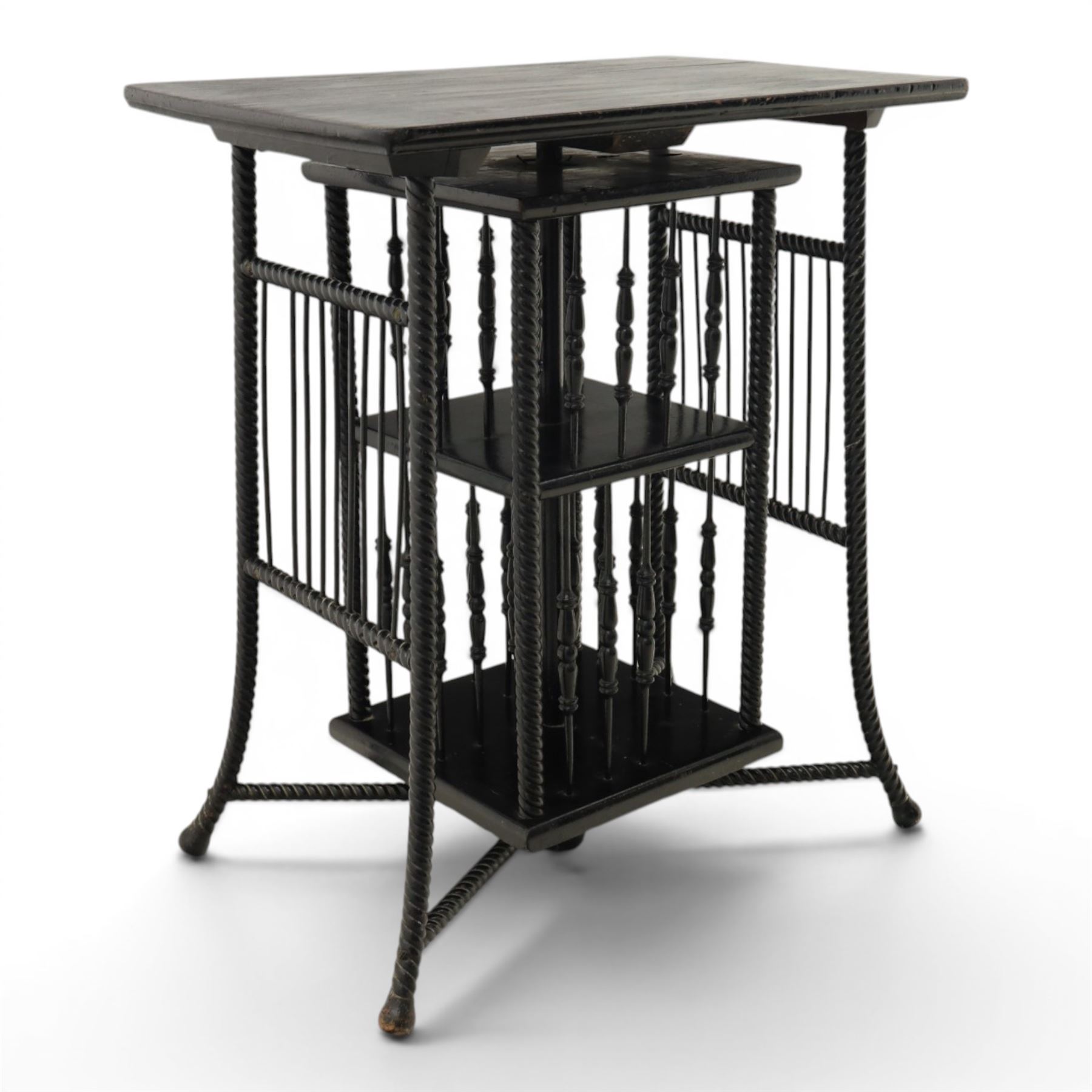 Edwardian black painted side table with incorporated revolving bookcase, supported on barley twist legs