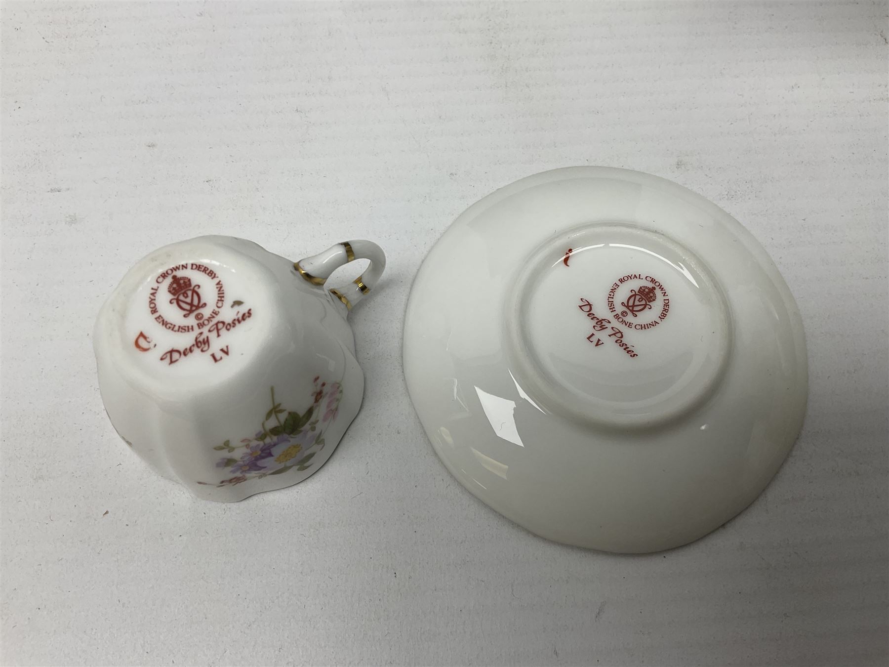 Poole pottery Dolphin, together with Royal Worcester miniature teacup and saucer, Royal Crown Derby miniature teacup and saucer in Derby Posies and one other