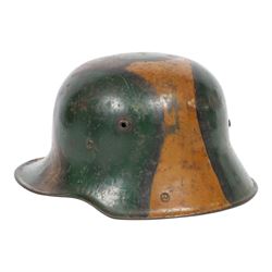 WWI German camouflage M17 helmet, with camouflage painted finish to the skull in green, brown and ochre colours with black separation lines, the interior with leather band which supports three pad leather lining, the pads stamped with indistinct marks 
