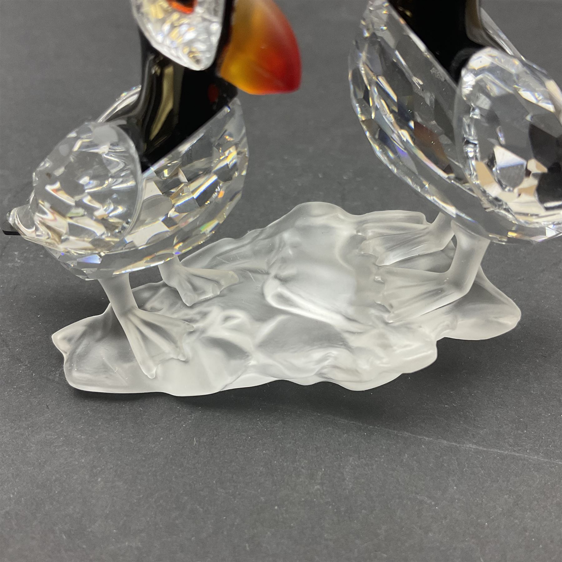 Three Swarovski Crystal bird figures, comprising Toucan, pair of puffins and pair of parrots on a branch, tallest H10cm