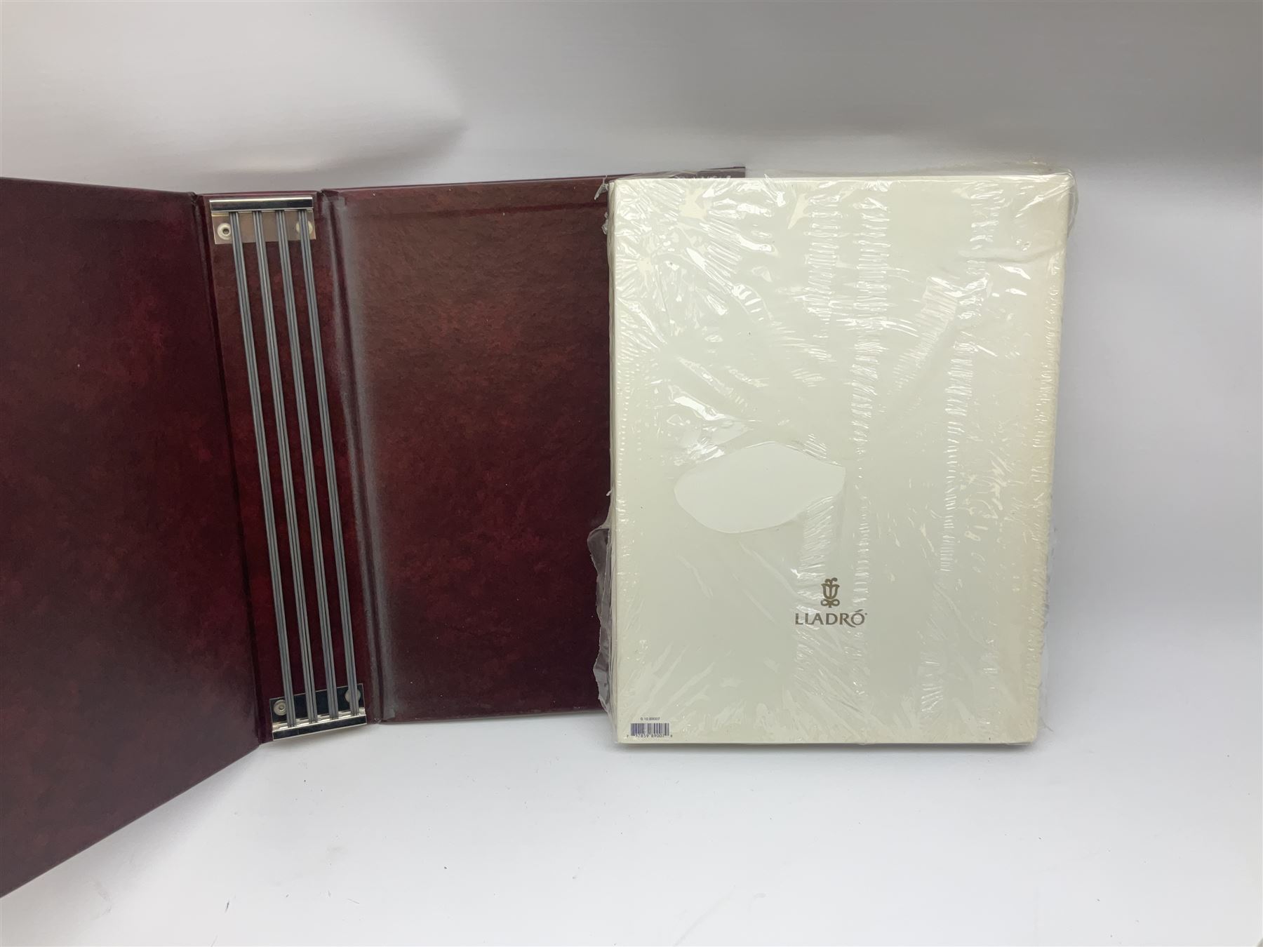 Lladro Collectors Society items, comprising of The Will to Create book, two candle holders; Sailing the Sea no 17665, Dolphins at Play no 17666, Plaque Bringing Us Together, key fob, leather wallet and a members joining pack with plaque, all in original boxes  