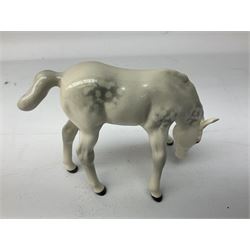 Collection of Beswick horses, including grey horse no.701, palomino foal no 836, grey stocky jogging mare no.855 etc, together two Royal Doulton horses, (8)