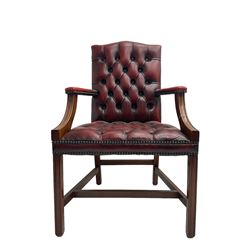 Georgian design mahogany framed Gainsborough style library armchair, upholstered in buttoned oxblood leather with studwork border