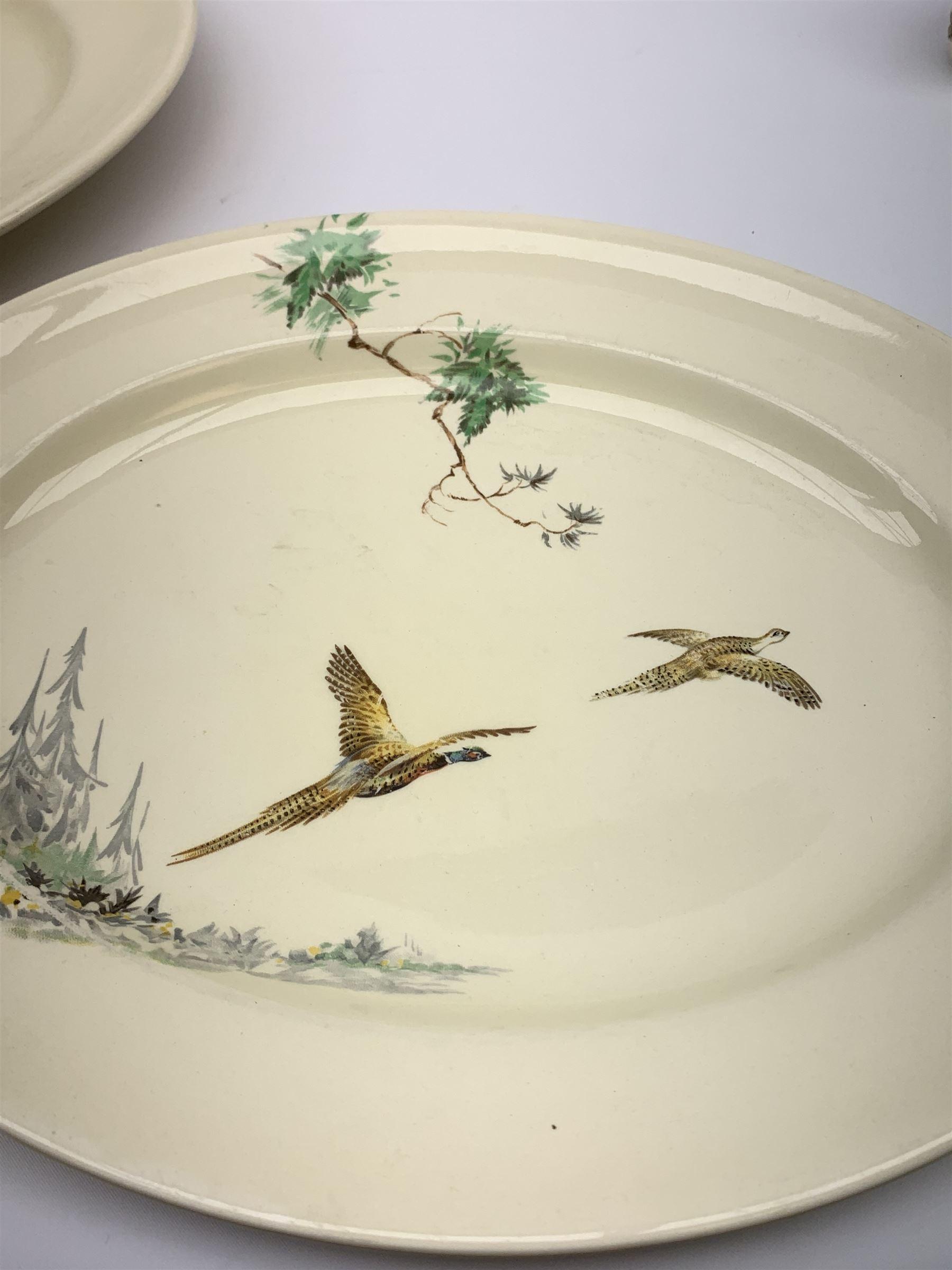 Royal Doulton The Coppice pattern dinner wares, comprising four dinner plates, three salad plates, two large bowls, three smaller, seven side plates, tureen and cover, two oval serving platters, sandwich plate, jug, three tea cups and six saucers, open sucrier, and three egg cups, together with two pieces of  Hartley Greens & Co, Leeds Pottery. 