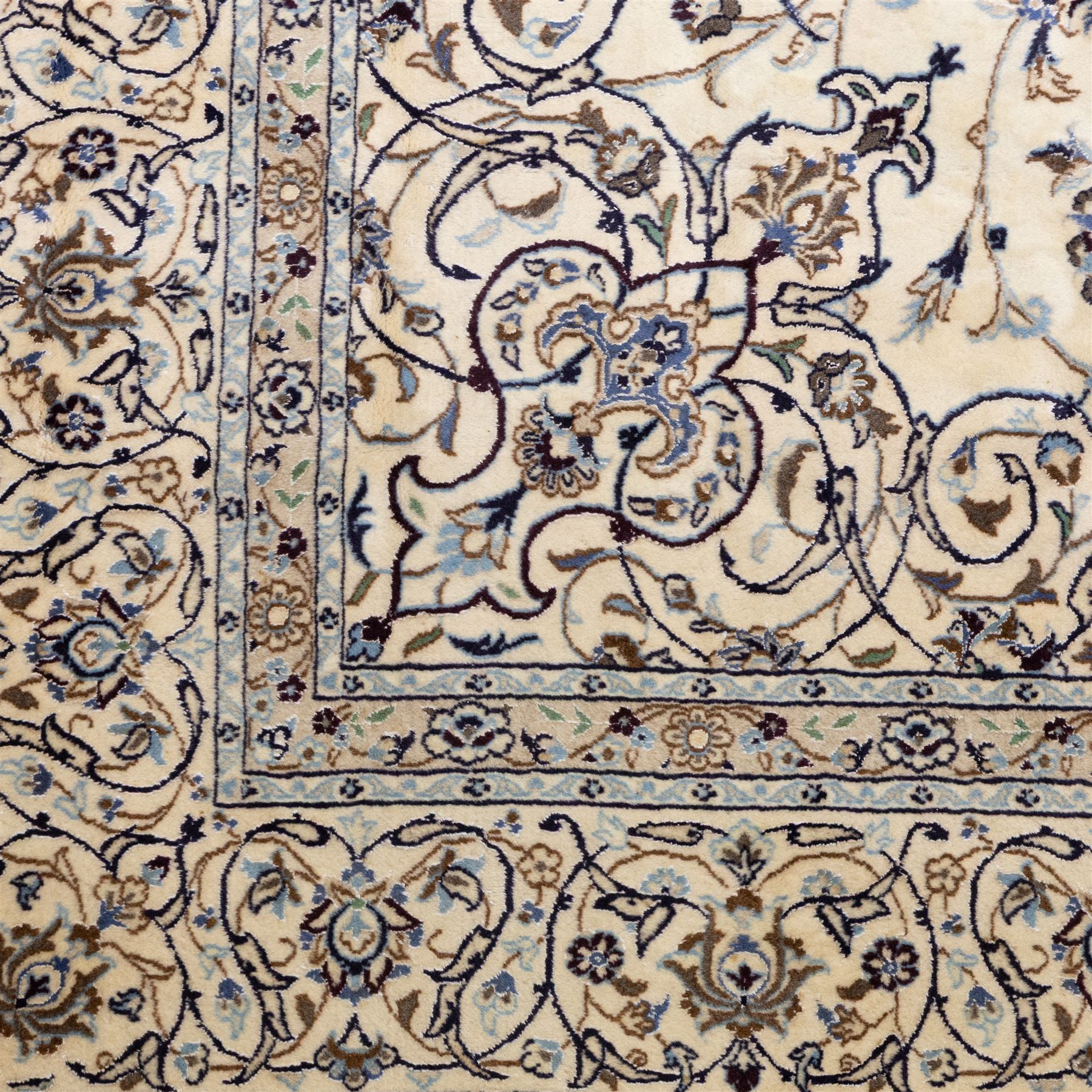Central Persian Nain hand-knotted carpet, wool with silk highlights, ivory field with central radiating medallion surround by an intricate arrangement of scrolling vines and floral motifs, within conforming spandrels and matching border, cotton fringe ends 